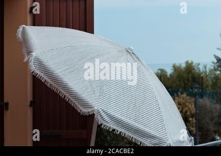 Ombrellone a righe all'ingresso di una casa (Pesaro, Italia, Europa) Foto Stock