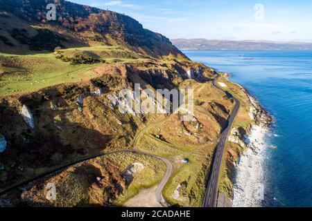 Costa atlantica nell'Irlanda del Nord, Causeway Coastal Route (Antrim Coast Road A2). Una delle strade costiere più panoramiche d'Europa. Vista aerea in Foto Stock