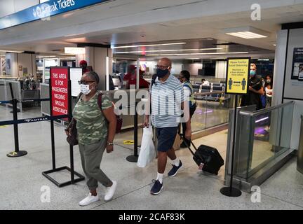 (200806) -- NEW YORK, 6 agosto 2020 (Xinhua) -- i passeggeri camminano da una piattaforma alla stazione di Penn a New York, gli Stati Uniti, il 6 agosto 2020. Il sindaco di New York, Bill de Blasio, mercoledì, ha annunciato i checkpoint di registrazione COVID-19 presso i punti di ingresso principali di New York City per garantire la conformità ai requisiti di quarantena dello stato di New York e per il contenimento del COVID-19. I viaggiatori che hanno visitato 35 stati o territori designati con tariffe di trasmissione COVID-19 elevate devono completare il modulo e la quarantena del viaggiatore del Dipartimento della Salute di New York per un periodo di Foto Stock