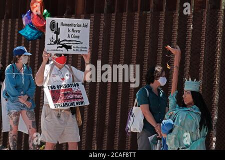 Nogales, Arizona, Stati Uniti. 6 agosto 2020. I membri dell'iniziativa Kino Border protestano per lo smantellamento dell'asilo al muro di confine di Nogales, Arizona. Save Asylum sentito dai richiedenti asilo, dai membri della società civile e dal clero di entrambe le parti del confine che protestano contro le amministrazioni Trump l’eliminazione del processo di asilo che essi affermano è contrario al diritto internazionale. Credit: Christopher Brown/ZUMA Wire/Alamy Live News Foto Stock