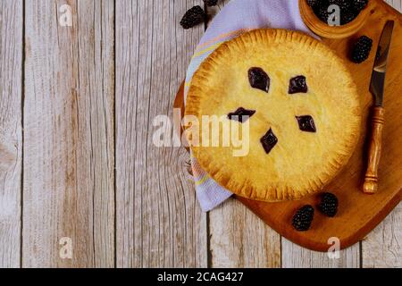 Torta di BlackBerry su tavolo di legno con coltello. Vista dall'alto. Foto Stock