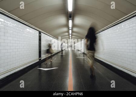 Gruppo di persone che scorrono attraverso un corridoio della metropolitana Foto Stock