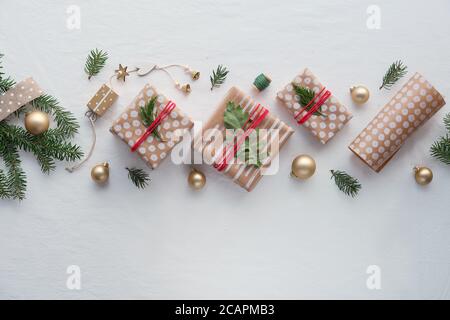 Regali di Natale fai da te e decorazioni fatte a mano. Celebrazione natalizia ecologica senza plastica naturale. Scatole regalo in carta da imballaggio artigianale, disposizione geometrica Foto Stock