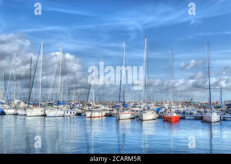 Barche ormeggiate nel porto di Alghero in una giornata nuvolosa. Elaborato per l'effetto di mappatura dei toni hdr Foto Stock