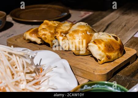 Panini arrostiti pieni di manzo e zuppa, conosciuti anche come kaobaozi, uno spuntino tradizionale a Xinjiang, in Cina. Foto Stock