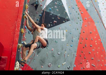 coppia pazza che va dentro per sport stupefacente. ragazzo e ragazza sono acuto sull'arrampicata spazio di copia Foto Stock