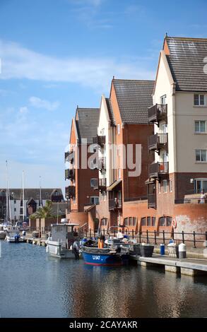 Appartamenti di lusso accanto a barche ormeggiate a Soverign Harbour, Eastbourne, Sussex, Inghilterra, UK. Foto Stock