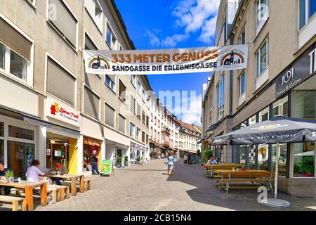 Aschaffenburg, Germania - Luglio 2020: Strada turistica con un anner che dice 'vicolo di andgasse - il vicolo di esperienza' nel centro storico della città il giorno d'estate Foto Stock