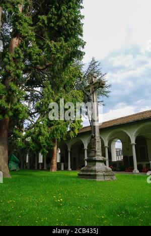 Croce sulla tomba nel cortile della Chiesa di San Leodegar (Hofkirche), una chiesa cattolica romana nel centro storico di Lucerna. Svizzera Foto Stock