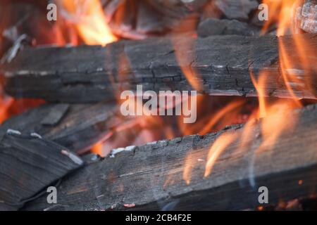 Primo piano di legna da ardere e calici in vecchio grill, fuoco selettivo Foto Stock