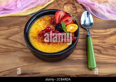 Cucina turca varietà di dessert. Muhallebi / Pudding fatto in casa. Budino di riso al forno latte turco dessert sutlac in casseruola di terracotta con foresta f Foto Stock