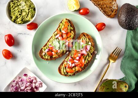 Deliziosi e sani toast di avocado vegano catturati dall'alto Foto Stock