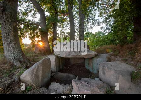 Lancken Granitz, Germania. 07 agosto 2020. Il sole tramonta dietro una tomba megalitica. Le tombe megalitiche nei pressi di Lancken-Granitz, sull'isola di Rügen, sono otto tombe della cultura neolitica dell'imbuto. Credit: Stefano Nosini/dpa-Zentralbild/ZB/dpa/Alamy Live News Foto Stock