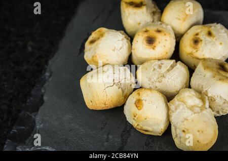 Delizioso pane al formaggio su fondo di pietra scuro. Cucina tradizionale brasiliana dallo stato di Minas Gerais. Foto Stock