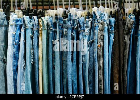 assortimento di jeans blu appesi in un negozio Foto Stock