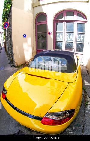 Porsche 924 gialla d'epoca, abbandonata di fronte ad un garage, Lione, Rodano, Auvergne regione Rodano-Alpi, Francia Foto Stock