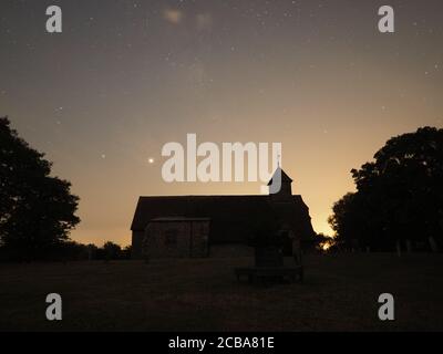 Harty, Kent, Regno Unito. 11 agosto 2020. Pianeti Saturno (a sinistra) e Giove (a destra) chiaramente visti nel cielo notturno sopra la chiesa di Harty nel Kent. Credit: James Bell/Alamy Live News Foto Stock