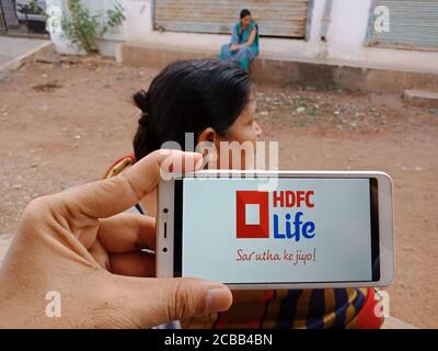 DISTRETTO KATNI, INDIA - 02 GIUGNO 2020: Una donna indiana che detiene smartphone con visualizzazione HDFC vita società di assicurazione logo sullo schermo, banca moderna Foto Stock