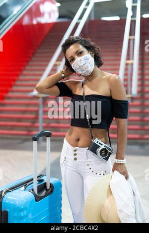 Ritratto di una donna bruna pronta a viaggiare durante il periodo pandemico di Covid-19. Foto Stock