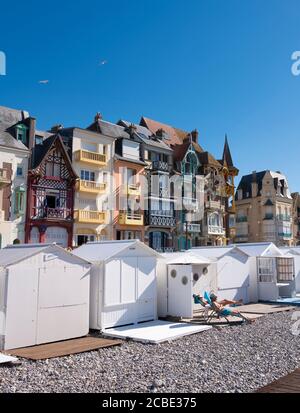 cabine spiaggia con persone e case colorate di mers les bains in normandia francese Foto Stock