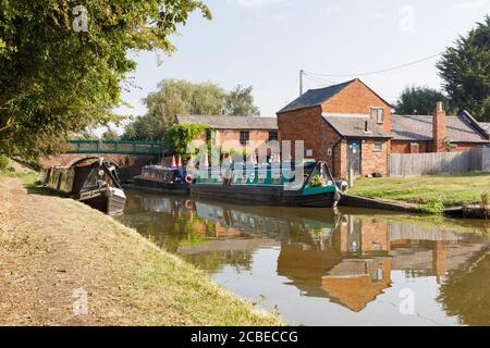 Crick, Northamptonshire, Regno Unito - 12/08/20: Barche a chiocciole ormeggiate a Crick Wharf sul Canal Grand Union, un percorso popolare per le vacanze in barca. Foto Stock