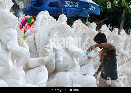 Artisti locali che fanno la statua del dio Ganesha usando Plaster di peris per la preparazione dell'occasione religiosa ganesh chaturthi Foto Stock