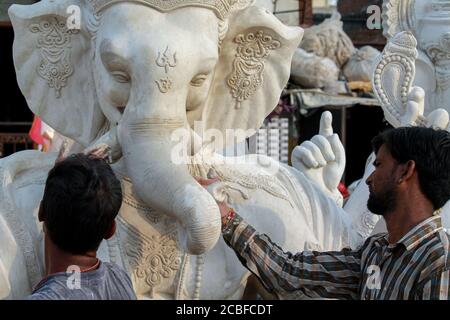 Artisti locali che fanno la statua del dio Ganesha usando Plaster di peris per la preparazione dell'occasione religiosa ganesh chaturthi Foto Stock