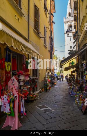 Un vicolo stretto nel centro storico dell'antico borgo peschereccio con negozi di souvenir e gente d'estate, Lerici, la Spezia, Liguria, Italia Foto Stock