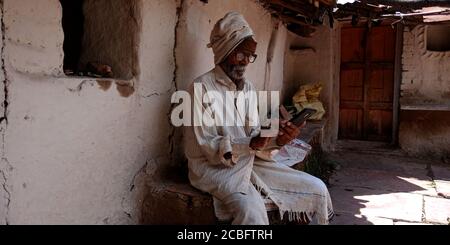 DISTRETTO KATNI, INDIA - 20 AGOSTO 2019: Un vecchio uomo di villaggio indiano che opera smartphone, concetto per l'apprendimento digitale della gente asiatica. Foto Stock