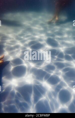 Vista sul fondo di una piscina con un effetto luce increspata Foto Stock