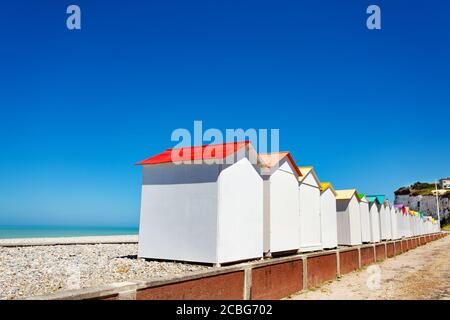 Panorama di cabine in legno e chioschi su Etretat, Francia spiaggia sul mare con cielo blu Foto Stock