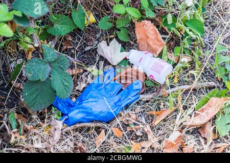 Scartare i guanti monouso sulla strada Foto Stock