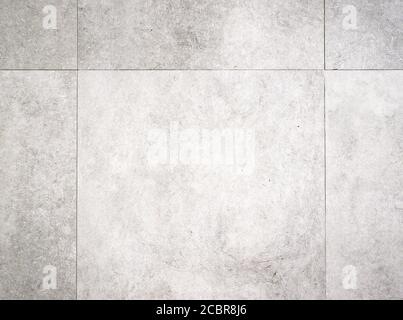 Struttura di sfondo grigio chiaro di una superficie di pavimento in piastrelle di cemento Foto Stock