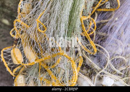 Blue Green Fishing Net and Orange Floats Display Background Foto Stock