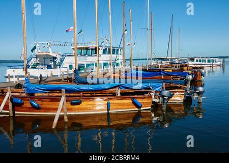 Steinhude, Germania, 29 maggio 2020: Barche a vela senza truccamento e una nave da escursione in attesa nel porto Foto Stock