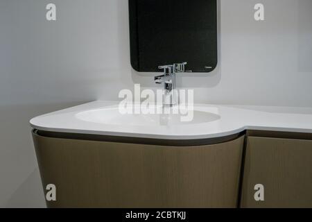 Lavabo in ceramica con piano bianco e miscelatore in metallo lucido. Foto di alta qualità Foto Stock