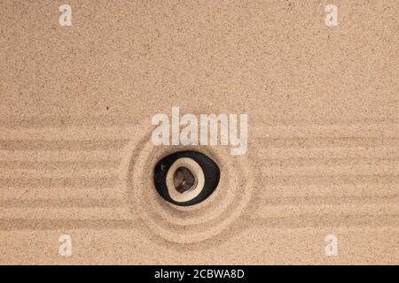 Piramide di pietre si trova al centro di un cerchio di sabbia. Vista dall'alto Foto Stock