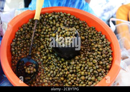 I capperi maltesi sono stati venduti nel vivace mercato domenicale di Marsaxlokk, Malta. Foto Stock