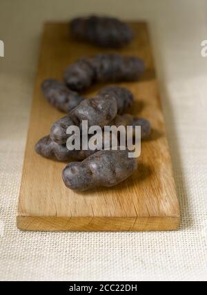 Tartufo de Chine blu-viola di patate sul tagliere Foto Stock