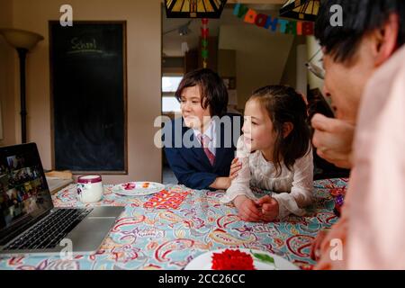 Una famiglia partecipa a una festa di compleanno zoom meeting con famiglia Foto Stock