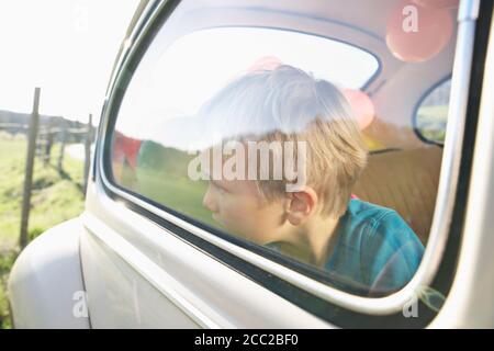 In Germania, in Renania settentrionale-Vestfalia, Colonia, ragazzo in auto guardando attraverso la finestrella, close up Foto Stock