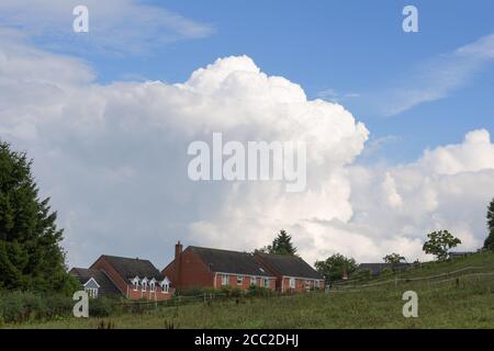 Romsley, Worcestershire, 17 agosto 2020. Il lunedì pomeriggio si formavano spettacolari nuvole sulle case di Romsley, Worcestershire, mentre il tuono e i fulmini continuavano a formarsi durante il caldo. Le piogge torrenziali hanno colpito la regione, ma si prevede che si calmeranno nella settimana successiva. Credito: Interrompi stampa Media/Alamy Live News Foto Stock