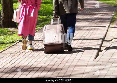 Il concetto di viaggio. I turisti con una grande valigia attraversano la città. Foto Stock