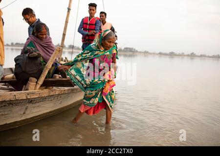 Le donne vengono evacuate in barca da un'area allagata al confine tra India e Nepal. Foto Stock