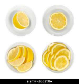 Limoni in ciotole di vetro bianco. Metà di limone appena tagliate, spicchi e fette. Agrumi maturi e gialli, utilizzati per scopi culinari. Limone di agrumi. Foto Stock