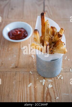 Patatine al tartufo fatte in casa con parmigiano. Ketchup condimento. Messa a fuoco selettiva. Foto Stock