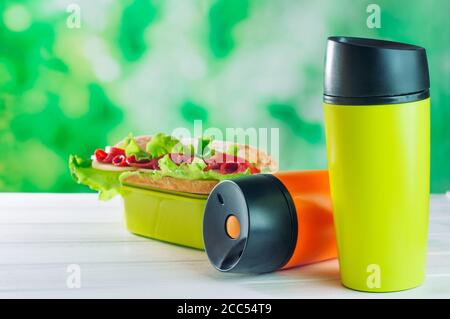 Thermos thermos thermos thermos vicino al pranzo scatola sul legno bianco tabella Foto Stock