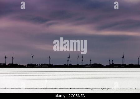 Meldorfer Bucht in serata con vista sul vento turbine Foto Stock