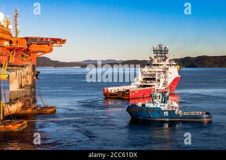 BERGEN, NORVEGIA - 2014 OTTOBRE 16. Nave offshore Siem Topaz e rimorchiatore Silex sotto l'operazione di movimentazione dell'ancora insieme alla perforazione semi-sommergibile Foto Stock