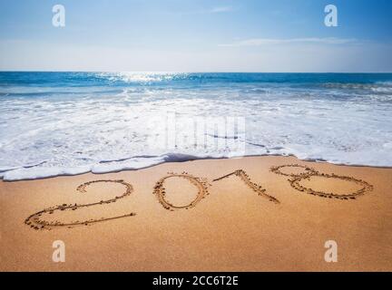 Il vecchio anno 2018 scade il concetto di spiaggia di sabbia tropicale oceano scritta L'immagine concettuale e il felice anno nuovo 2019 sono in arrivo Foto Stock